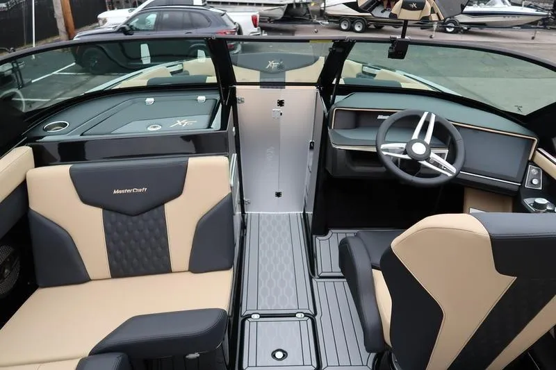 Slide: The Image of 2025 MasterCraft XT22 boat interior with modern seating and steering wheel design. - 43