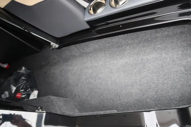 Slide: The Image of Interior view of 2025 MasterCraft XT22 boat storage compartment with cup holders. - 46