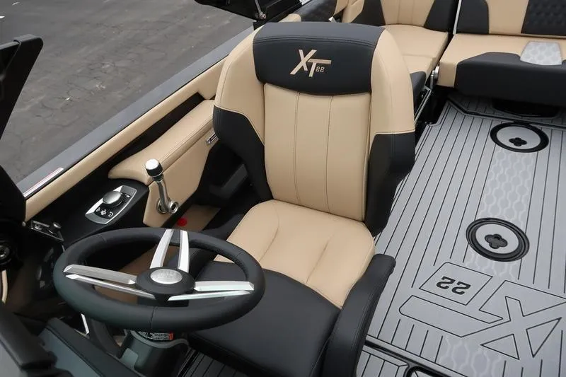 Slide: The Image of 2025 MasterCraft XT22 boat interior with steering wheel and seating. - 48