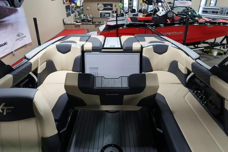 Slide: The Image of Interior of 2025 MasterCraft XT22 boat with beige and black seating. - 52