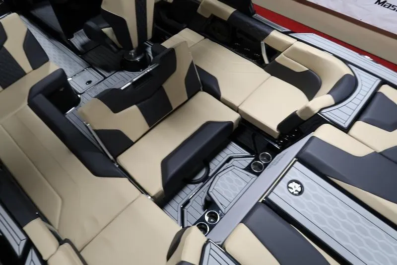 Slide: The Image of 2025 MasterCraft XT22 interior with beige and black seating, showcasing luxury and comfort. - 53