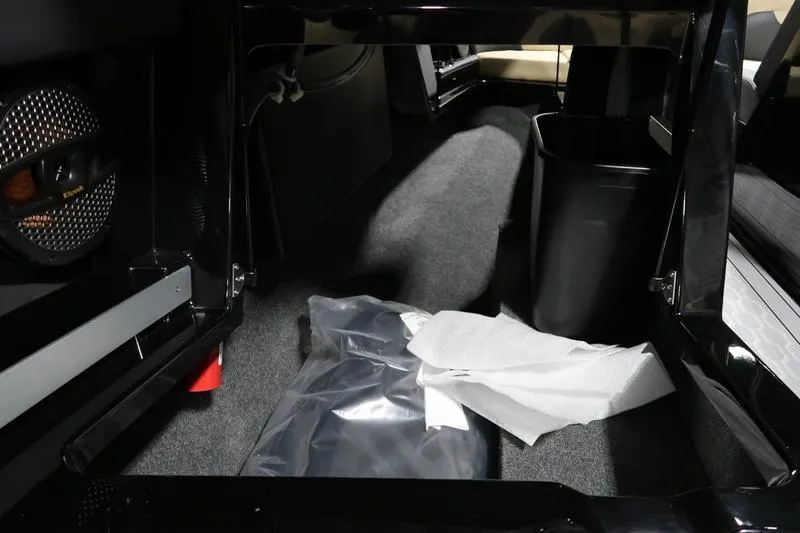 Slide: The Image of Interior storage of 2025 MasterCraft XT22 boat with speaker and accessories. - 56