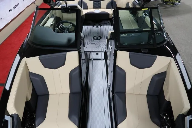 Slide: The Image of 2025 MasterCraft XT22 boat interior with beige and black seating, sleek design. - 61