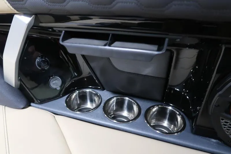 Slide: The Image of Interior of 2025 MasterCraft XT22 boat with cup holders and storage compartments. - 62