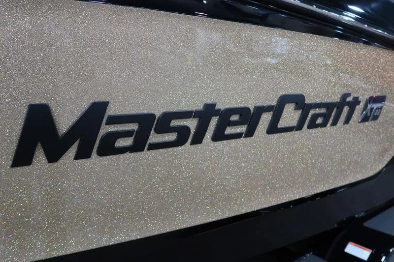 Slide: The Image of 2025 MasterCraft XT22 boat logo on a glittery surface. - 8