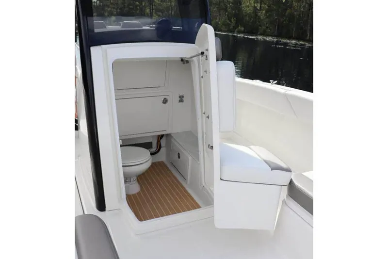 Slide: The Image of Manufacturer Provided Image: 2026 World Cat 280 CC-X boat interior with compact bathroom and seating. - 7