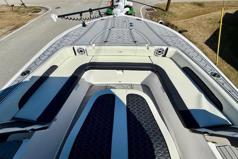 Slide: The Image of 2024 Tidewater 3100 Carolina Bay boat interior with cushioned seating and deck design. - 15