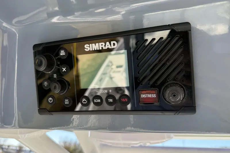 Slide: The Image of Simrad marine radio on 2024 Tidewater 3100 Carolina Bay boat dashboard. - 20