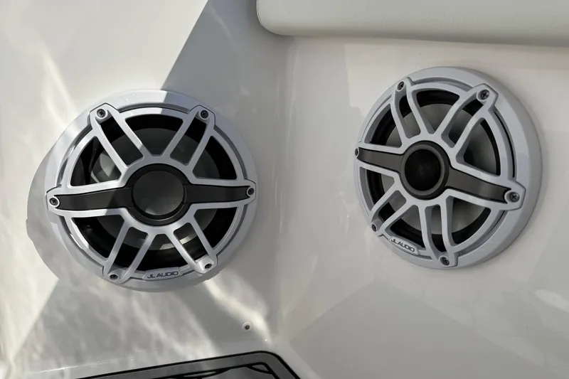 Slide: The Image of 2024 Tidewater 3100 Carolina Bay boat speakers, JL Audio, white and black design. - 23