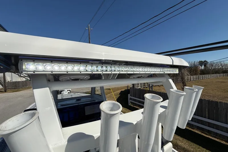Slide: The Image of 2024 Tidewater 3100 Carolina Bay boat with LED light bar and rod holders. - 25