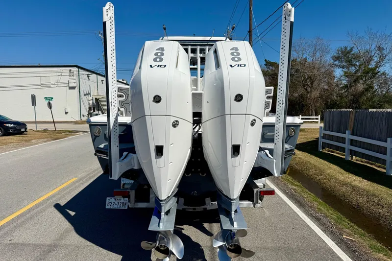 Slide: The Image of 2024 Tidewater 3100 Carolina Bay boat with dual 400 V10 engines on a trailer. - 3