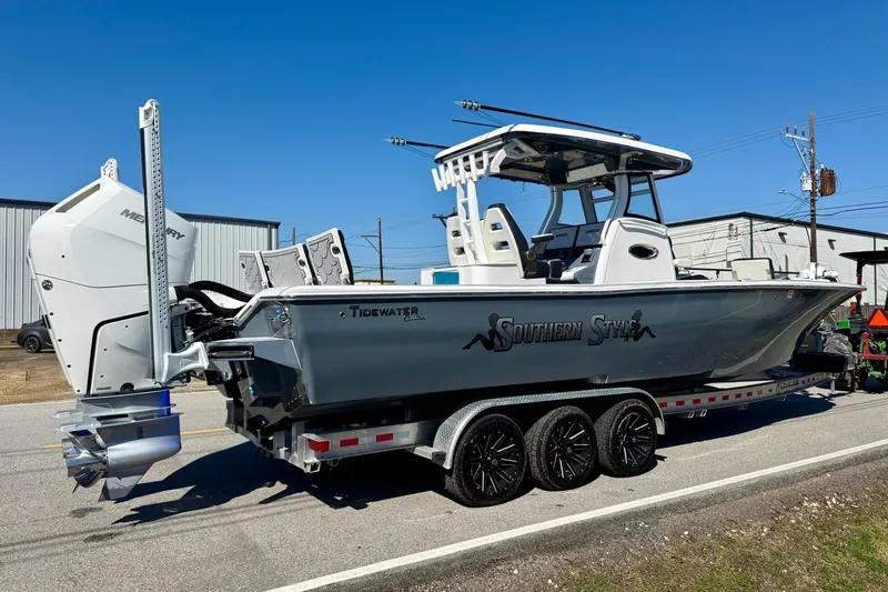 Slide: The Image of 2024 Tidewater 3100 Carolina Bay boat on trailer, featuring sleek design and powerful Mercury engine. - 4
