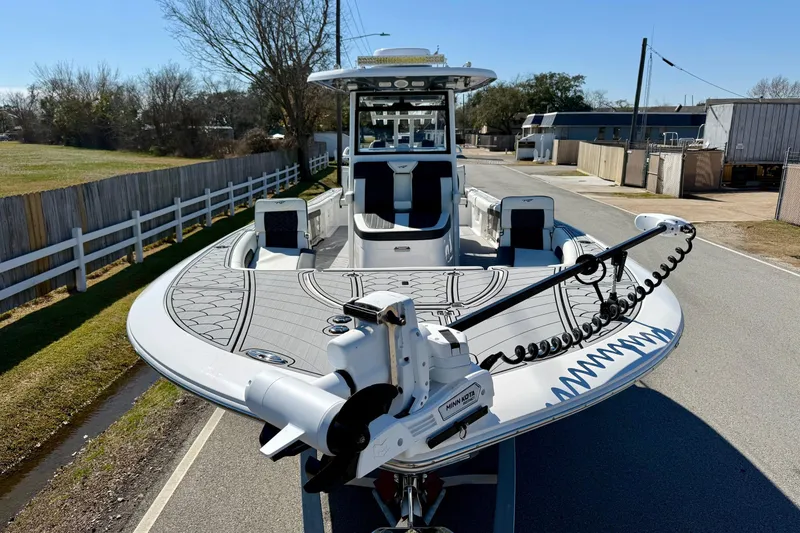Slide: The Image of 2024 Tidewater 3100 Carolina Bay boat on road, featuring advanced fishing equipment. - 6