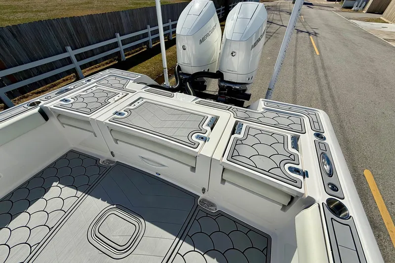 Slide: The Image of 2024 Tidewater 3100 Carolina Bay boat with dual Mercury engines, featuring stylish deck design. - 8