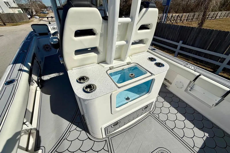 Slide: The Image of 2024 Tidewater 3100 Carolina Bay boat interior with seating and storage features. - 9