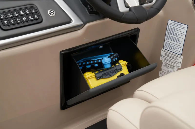 Slide: The Image of 2026 Ranger Reata 220FC boat interior with tan and black seating in a workshop. - 41