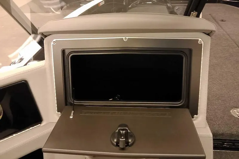 Slide: The Image of 2026 Ranger 620xFS Pro boat dashboard with open storage compartment. - 19