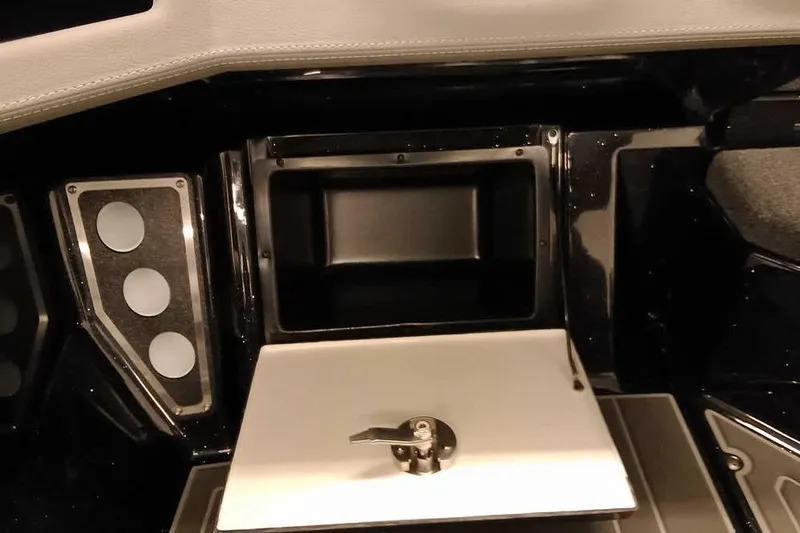 Slide: The Image of Interior of 2026 Ranger 620xFS Pro boat, featuring storage compartment and control panel. - 22