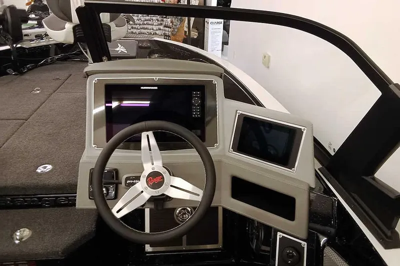 Slide: The Image of 2026 Ranger 620xFS Pro boat dashboard with steering wheel and digital displays. - 25