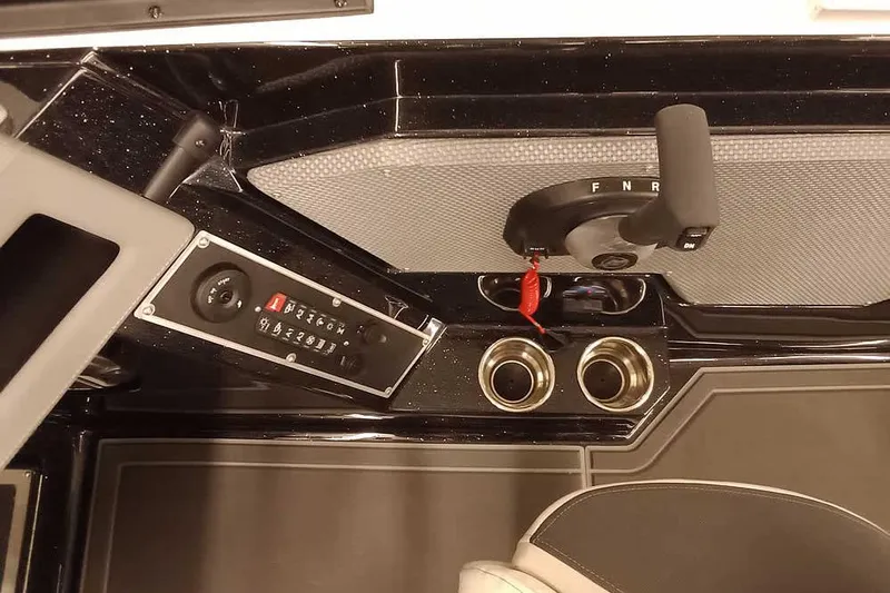 Slide: The Image of 2026 Ranger 620xFS Pro boat console with controls and cup holders. - 26