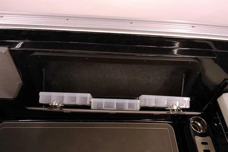 Slide: The Image of 2026 Ranger 620xFS Pro storage compartment with organized tackle boxes. - 32