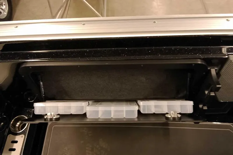 Slide: The Image of 2026 Ranger 620xFS Pro storage compartment with organized tackle boxes. - 33