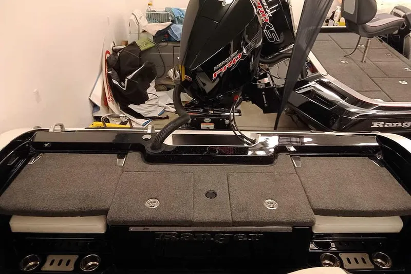 Slide: The Image of 2026 Ranger 620xFS Pro boat interior with motor, storage compartments, and seating. - 34