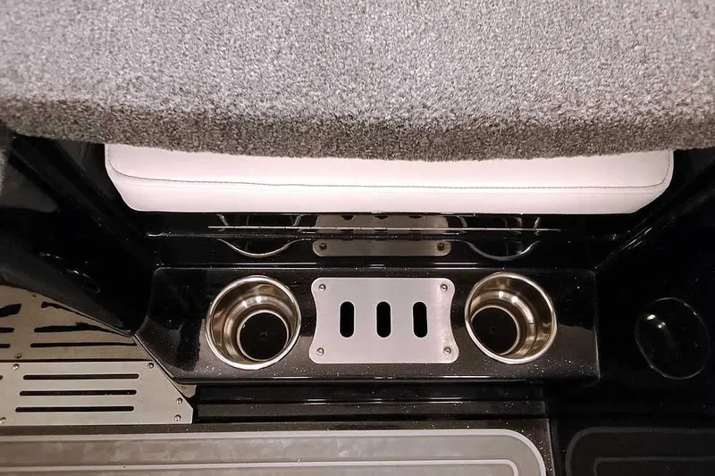 Slide: The Image of 2026 Ranger 620xFS Pro boat interior with cup holders and cushioned seating. - 37