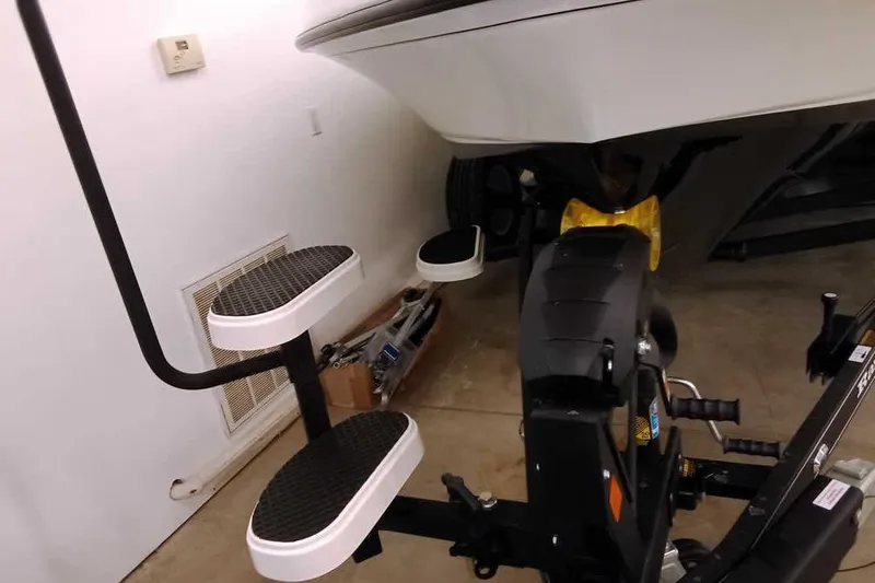 Slide: The Image of 2026 Ranger 620xFS Pro boat trailer with step ladder in a garage. - 5