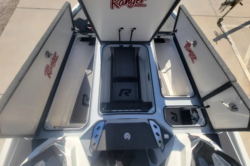 Slide: The Image of 2023 Ranger Z520R boat storage compartments open, showcasing spacious interior design. - 6