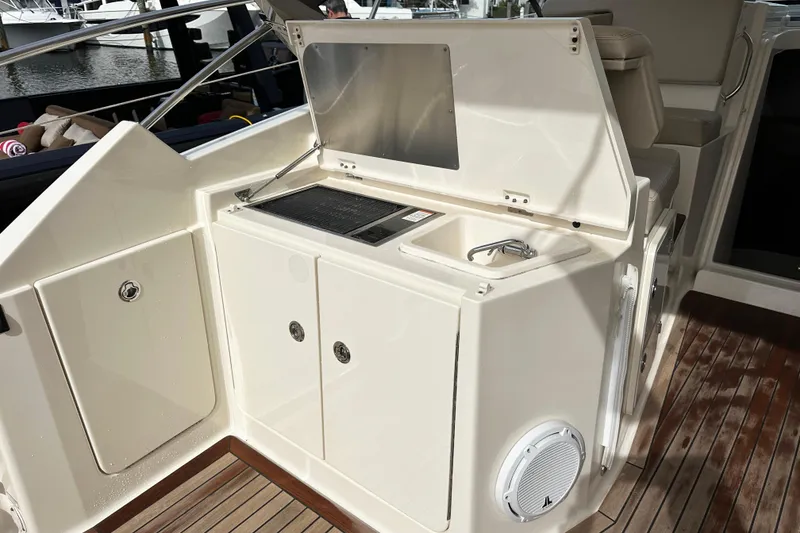 Slide: The Image of 2014 Pursuit SC 365i Sport Coupe yacht interior with sink and storage area. - 11