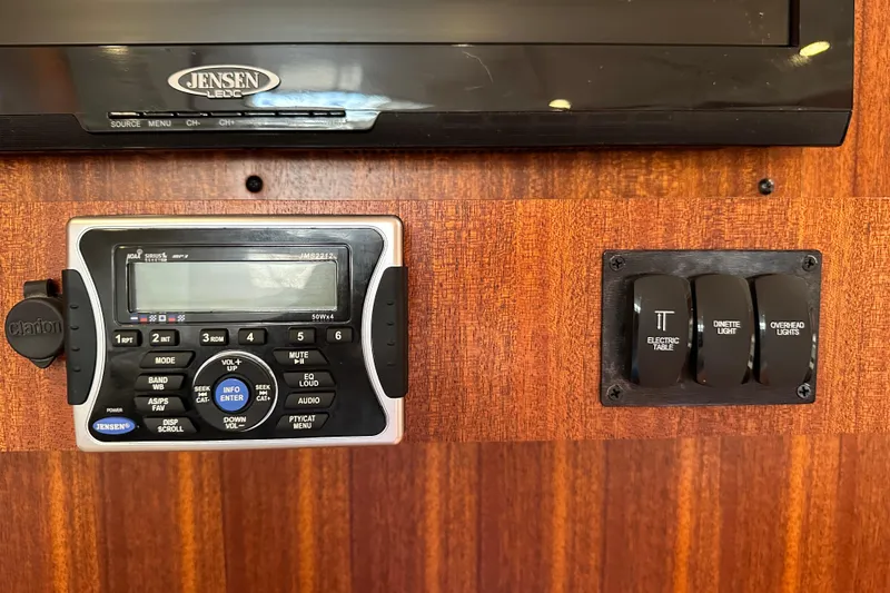 Slide: The Image of Control panel and switches in a 2014 Pursuit SC 365i Sport Coupe boat. - 23