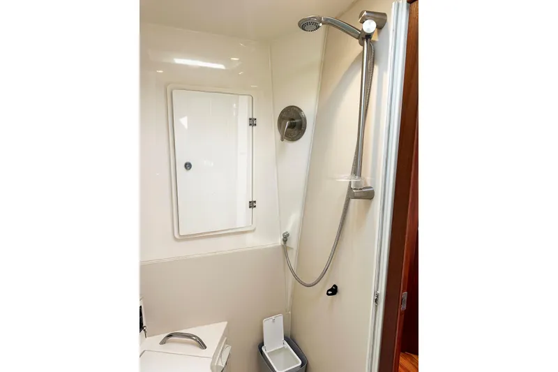 Slide: The Image of 2014 Pursuit SC 365i Sport Coupe shower area with modern fixtures and storage cabinet. - 27