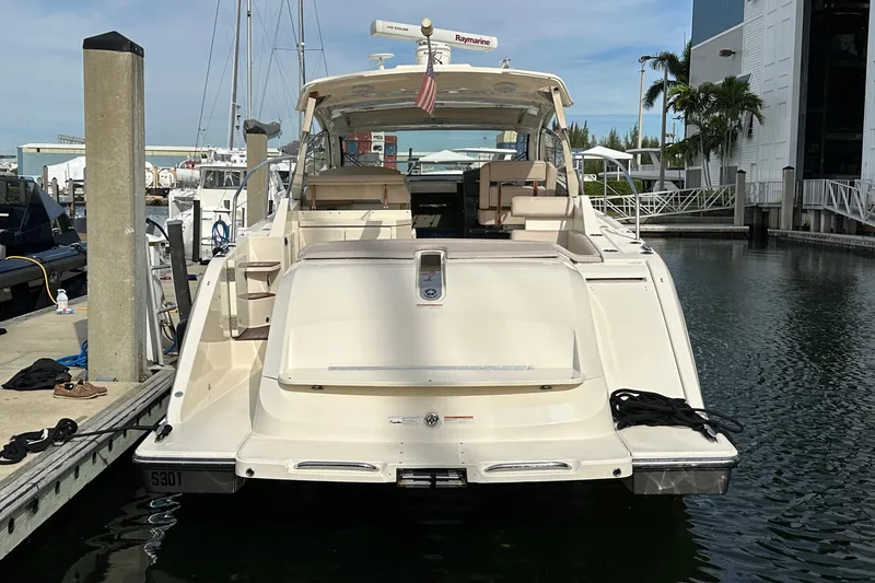Slide: The Image of 2014 Pursuit SC 365i Sport Coupe docked at marina, rear view. - 3