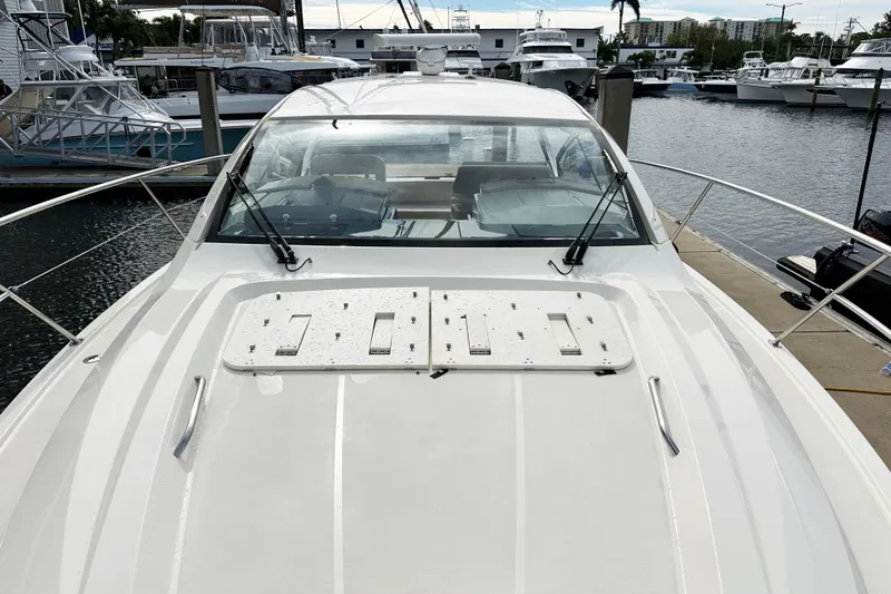 Slide: The Image of 2014 Pursuit SC 365i Sport Coupe docked at marina, showcasing sleek design and spacious deck. - 4