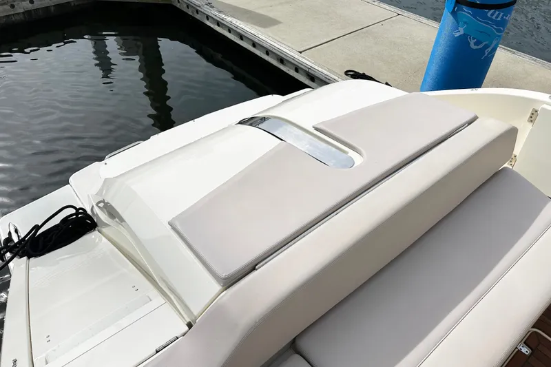 Slide: The Image of 2014 Pursuit SC 365i Sport Coupe at dock, featuring sleek design and cushioned seating. - 5