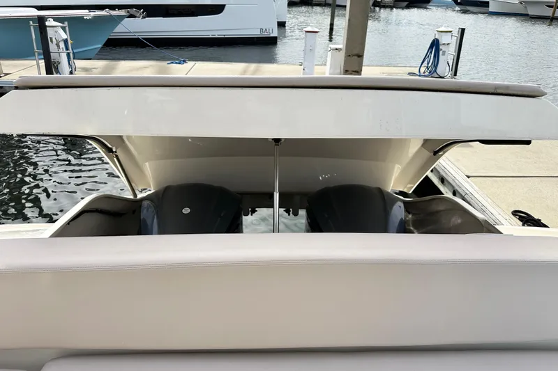 Slide: The Image of 2014 Pursuit SC 365i Sport Coupe engine compartment at marina dock. - 6