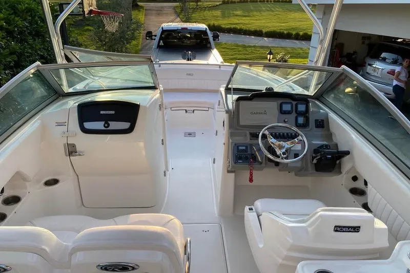 Slide: The Image of 2015 Robalo R247 Dual Console boat interior with steering wheel and dashboard. - 7