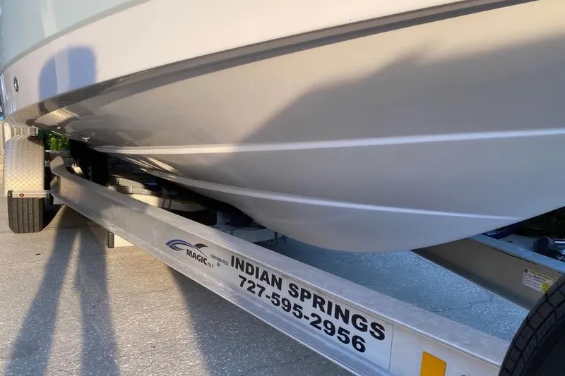 Slide: The Image of 2015 Robalo R247 Dual Console boat on trailer, Indian Springs contact info visible. - 9