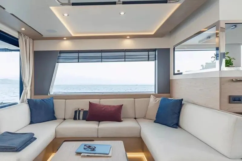 Slide: The Image of Luxurious interior of 2026 Beneteau Grand Trawler 62 with elegant seating and ocean view. - 6