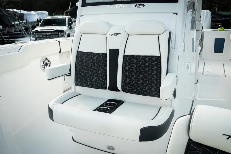 Slide: The Image of 2026 Tidewater 282 CC Adventure boat seating with cup holders, featuring modern design and comfort. - 13