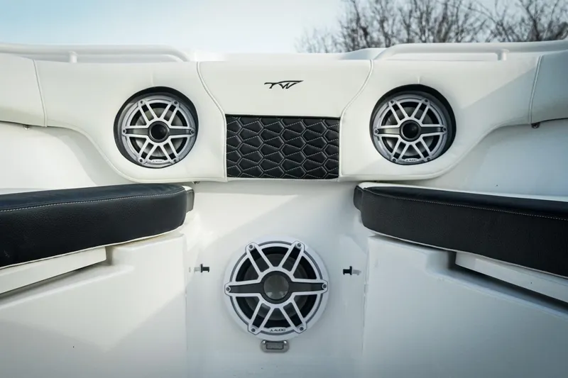 Slide: The Image of 2026 Tidewater 282 CC Adventure boat interior with speakers and cushioned seating. - 15