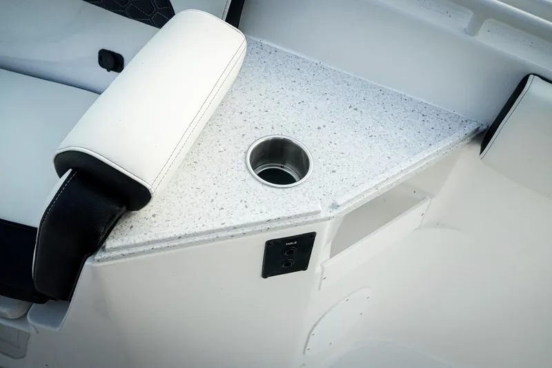 Slide: The Image of 2026 Tidewater 282 CC Adventure boat interior with cup holder and cushioned seating. - 16