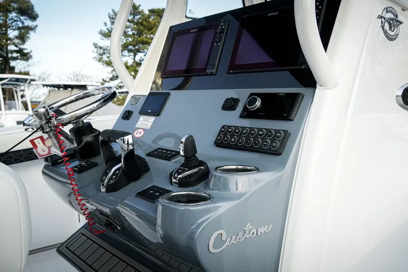 Slide: The Image of 2026 Tidewater 282 CC Adventure boat dashboard with advanced controls and navigation systems. - 21