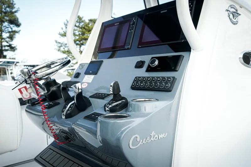 Slide: The Image of 2026 Tidewater 282 CC Adventure boat dashboard with advanced controls and dual screens. - 23