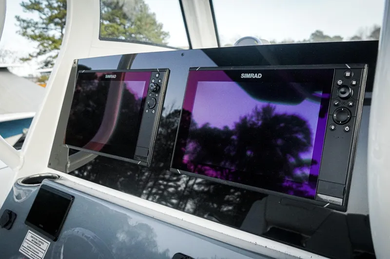 Slide: The Image of Simrad displays on 2026 Tidewater 282 CC Adventure boat dashboard. - 24