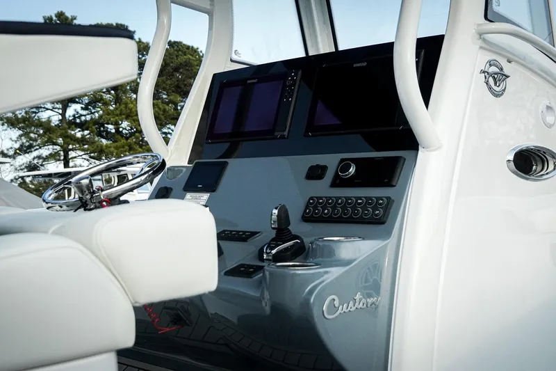 Slide: The Image of 2026 Tidewater 282 CC Adventure boat dashboard with modern controls and steering wheel. - 29
