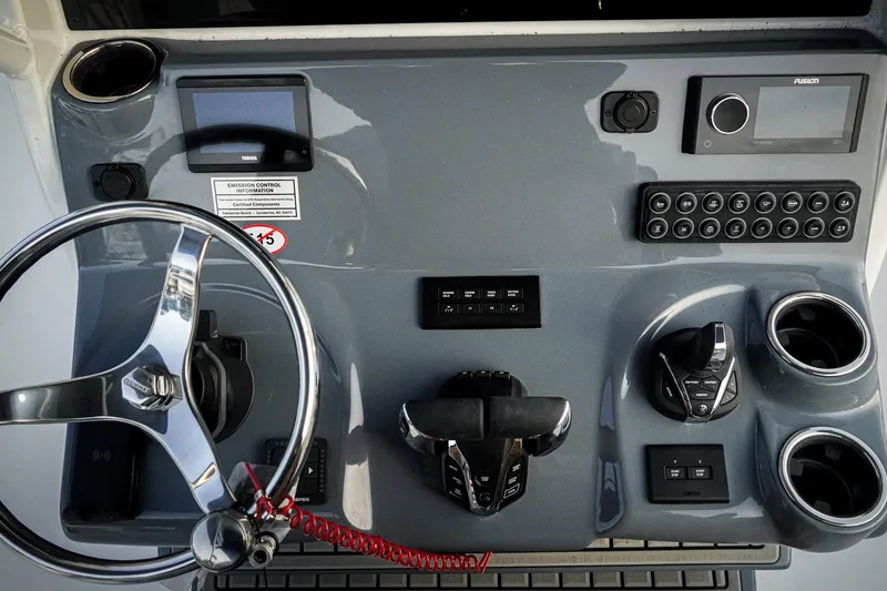 Slide: The Image of 2026 Tidewater 282 CC Adventure boat dashboard with steering wheel and control panel. - 30
