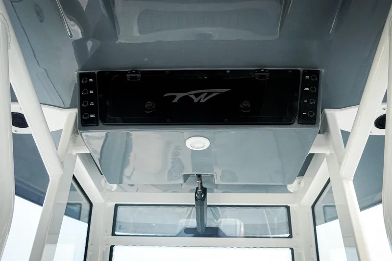 Slide: The Image of 2026 Tidewater 282 CC Adventure boat interior with control panel and windows. - 31