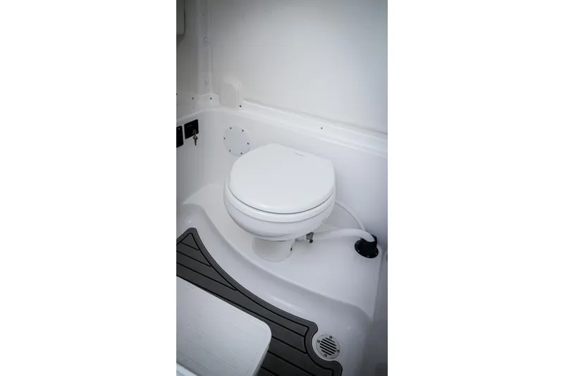 Slide: The Image of 2026 Tidewater 282 CC Adventure boat interior with compact marine toilet. - 35